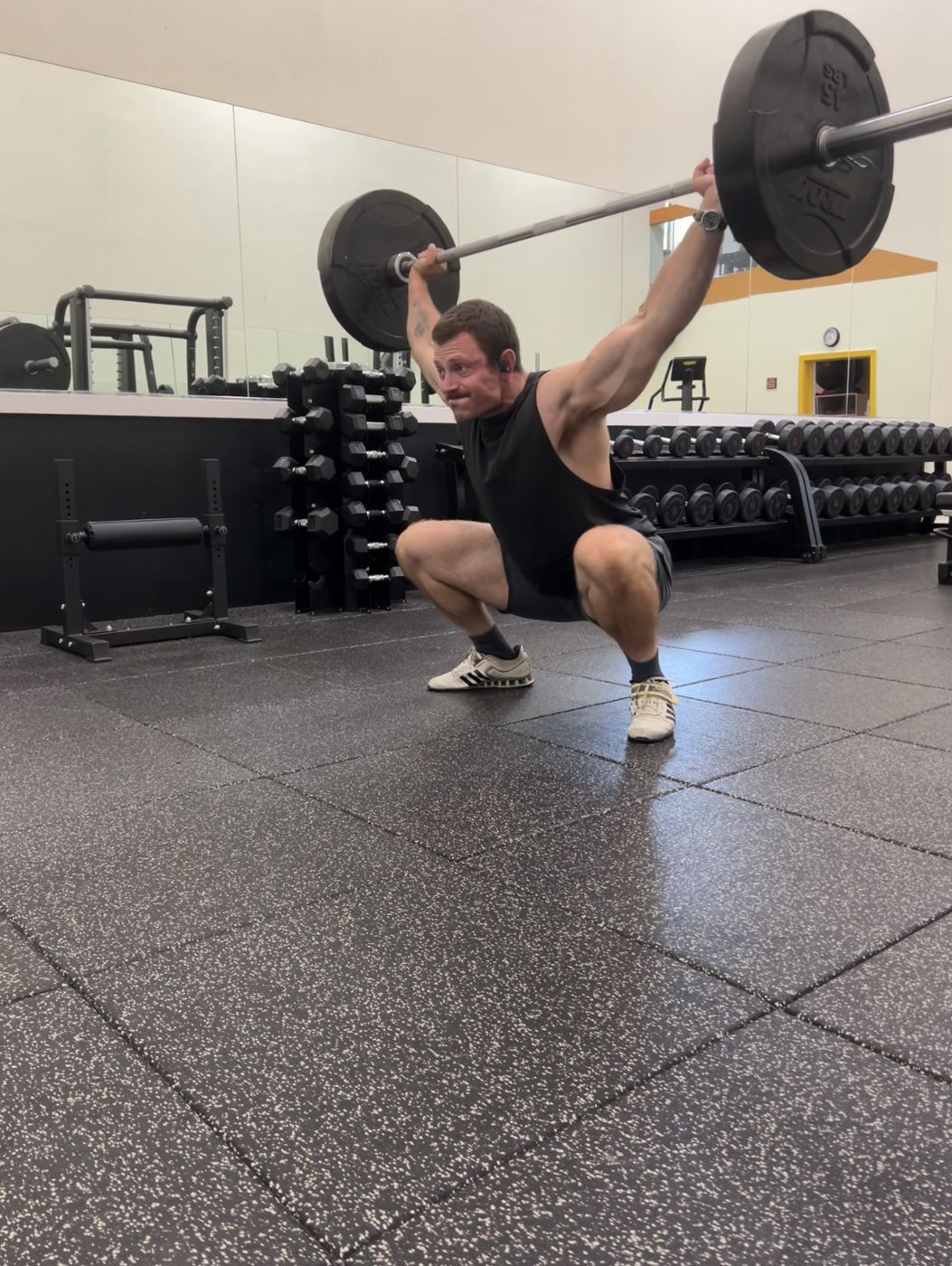 Tanner in a deep overhead squat in the gym
