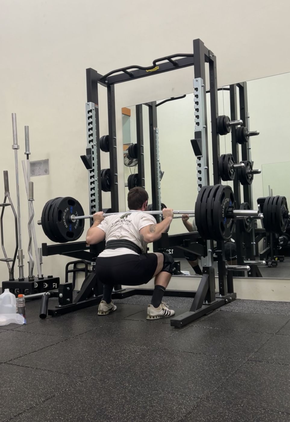 Tanner squatting 405 pounds in a power rack
